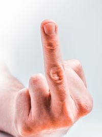 Close-up of human hand against white background