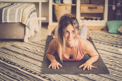 Woman looking away while lying down on floor