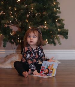 Portrait of toddler under christmas tree