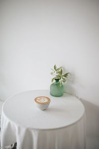 Close-up of white rose in plate on table