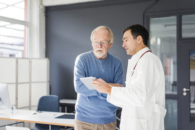 Doctor showing tablet to patient in medical practice