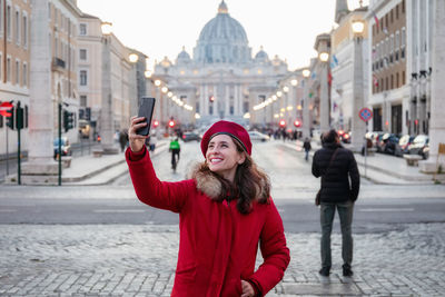 Portrait of woman with umbrella in city