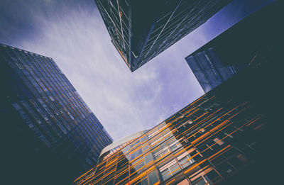 Low and wide angle view of modern buildings against sky