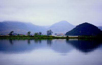 Scenic view of lake and mountains against sky