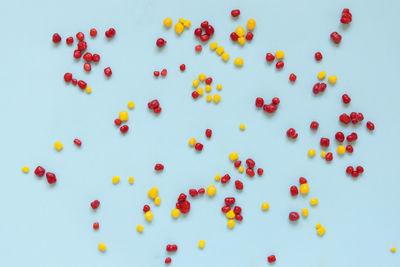 High angle view of multi colored confetti on white background