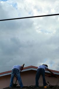 Low angle view of man standing against sky