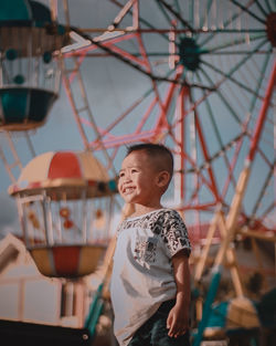 Cute boy looking at amusement park