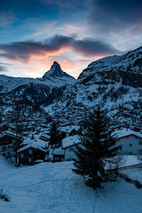 Scenic view of snowcapped mountains against sky during sunset