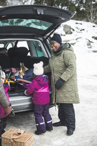 Full length of father and daughter in snow