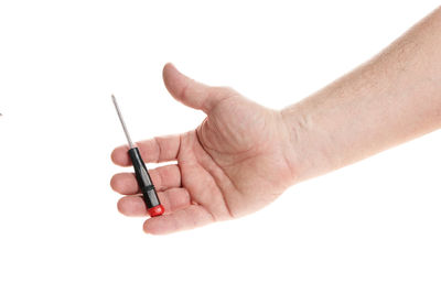 Close-up of hand holding eyeglasses against white background