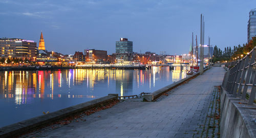 Illuminated buildings along river