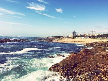 Scenic view of beach against blue sky