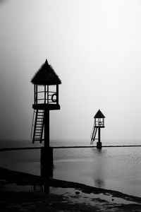 Lifeguard hut on sea against sky