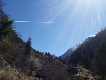 Scenic view of vapor trail against blue sky