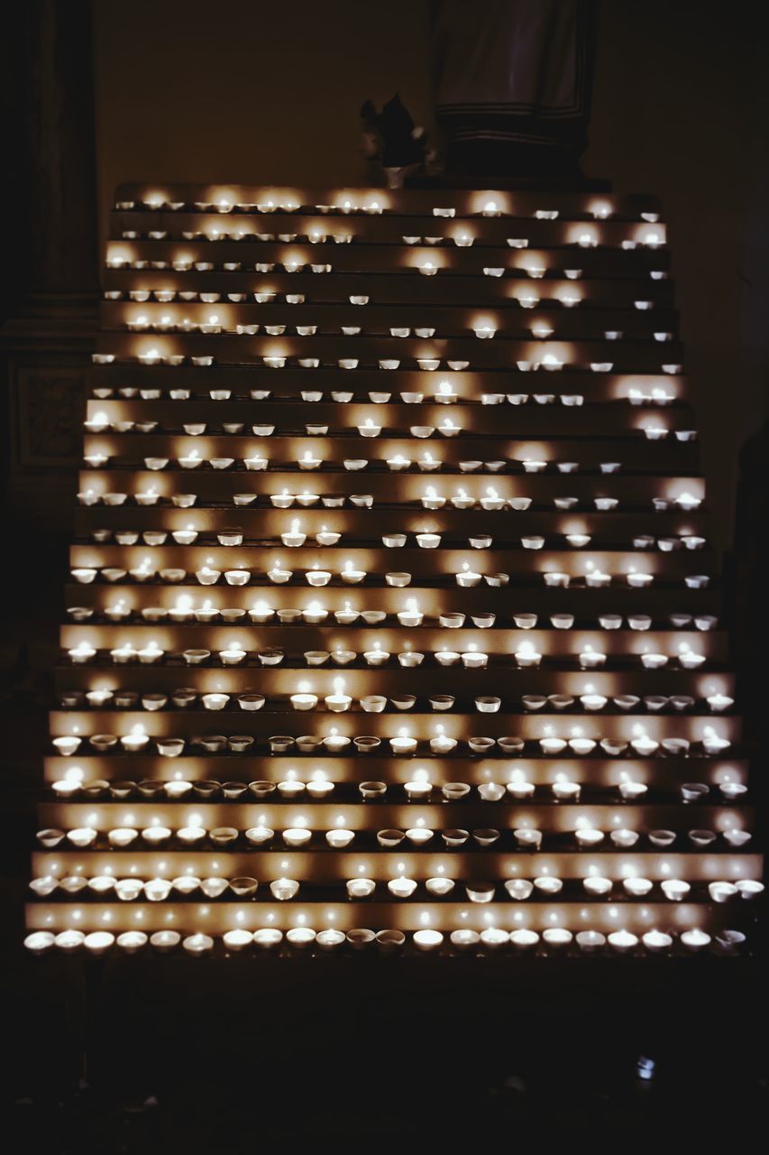 LOW ANGLE VIEW OF ILLUMINATED LIGHTS AT HOME