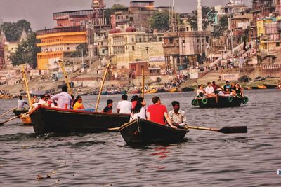 People on boats in sea