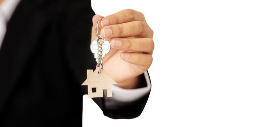 Close-up of hand holding camera over white background