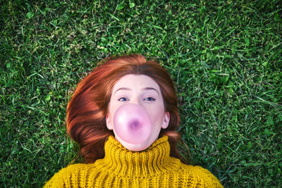 Portrait of man lying on grass