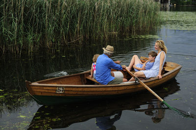 Family in rowing boat on lake