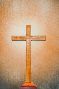 Close-up of cross against wall