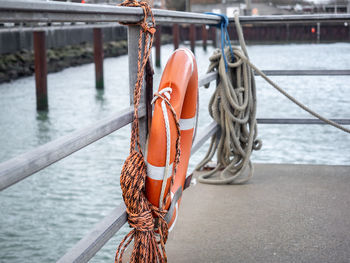 Rope tied to wooden post in river