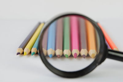 Close-up of multi colored pencils on white background