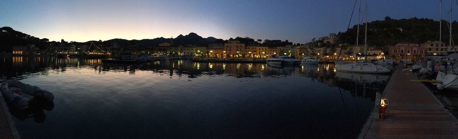 Reflection of buildings in lake at sunset