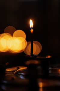 Close-up of illuminated candles on table