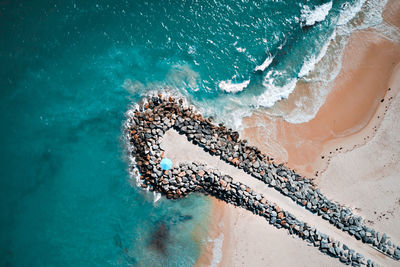 High angle view of sea waves on beach