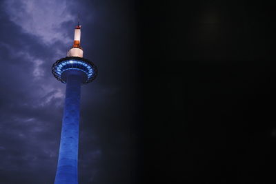 Low angle view of illuminated tower against sky at night