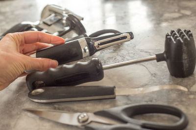 Midsection of person working on barbecue grill