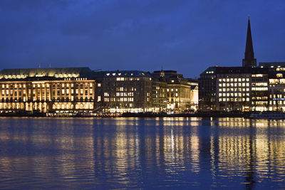 Reflection of buildings in city at waterfront