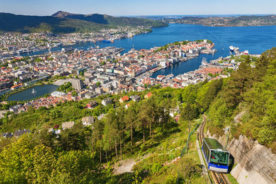 High angle view of townscape by sea against sky