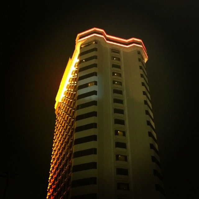 illuminated, low angle view, building exterior, architecture, night, built structure, skyscraper, city, tall - high, modern, tower, building, clear sky, office building, sky, no people, outdoors, tall, dark, light - natural phenomenon