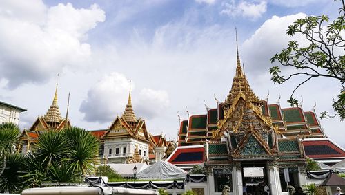 Low angle view of pagoda against cloudy sky