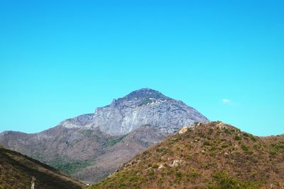 Scenic view of mountains against clear blue sky