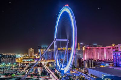 Illuminated ferris wheel at night