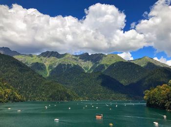 Scenic view of lake by mountains against sky