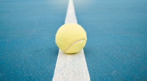 Close-up of tennis ball on table