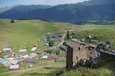 Scenic view of landscape and houses against mountains
