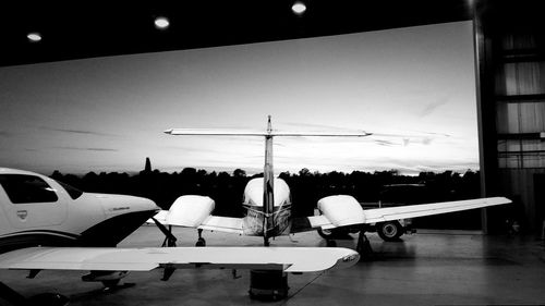 Airplane on airport runway against sky