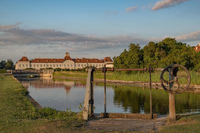 Scenic view of lake by building against sky