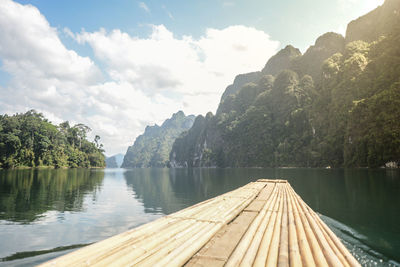 Scenic view of lake by trees against sky