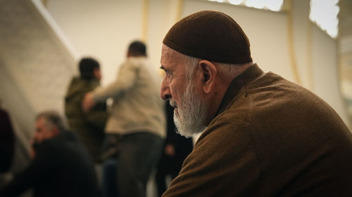 Rear view of man standing against wall