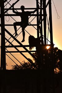 Low angle view of silhouette man against sky at sunset