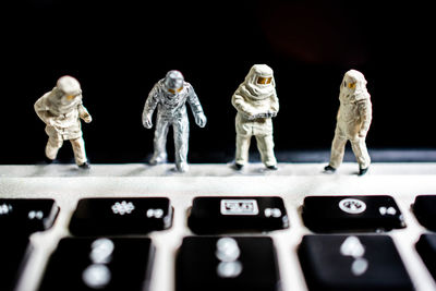 Close-up of figurines on laptop keyboard