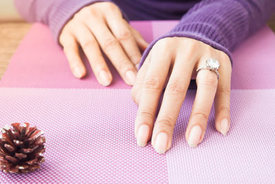 Cropped hands of woman with ring