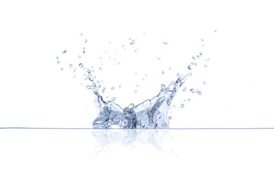 Close-up of splashing water against white background