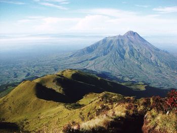 Scenic view of mountains against cloudy sky