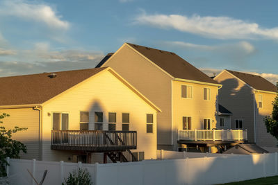 Houses against sky during sunset